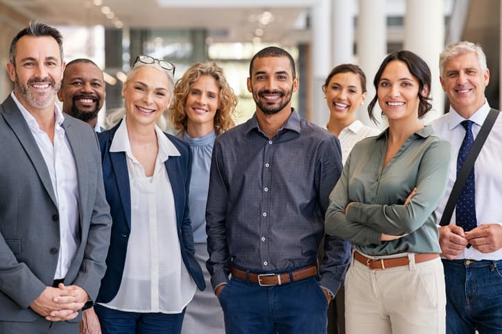 A professional team standing together in an office