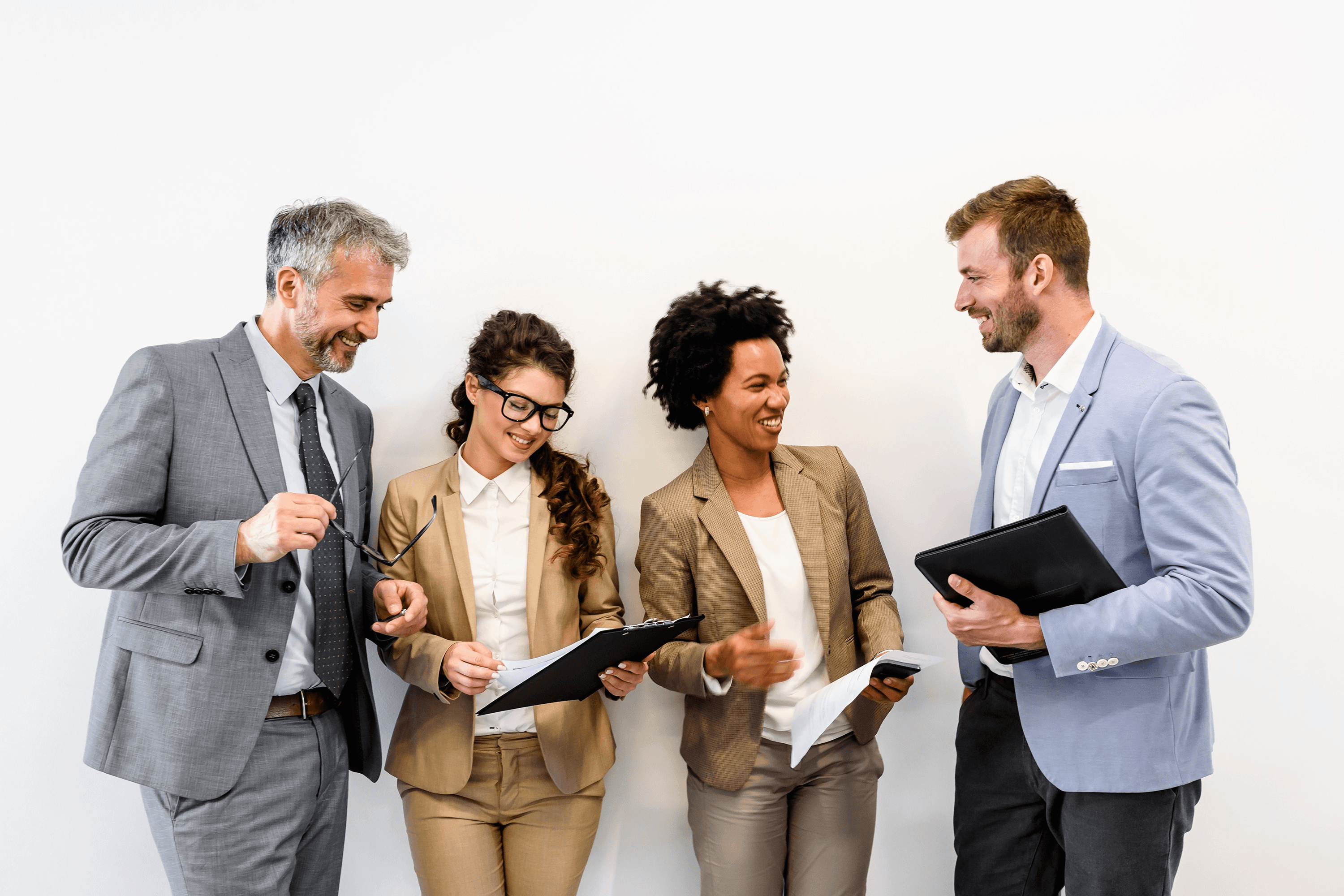 Four professionals reviewing documents and discussing talent strategy together