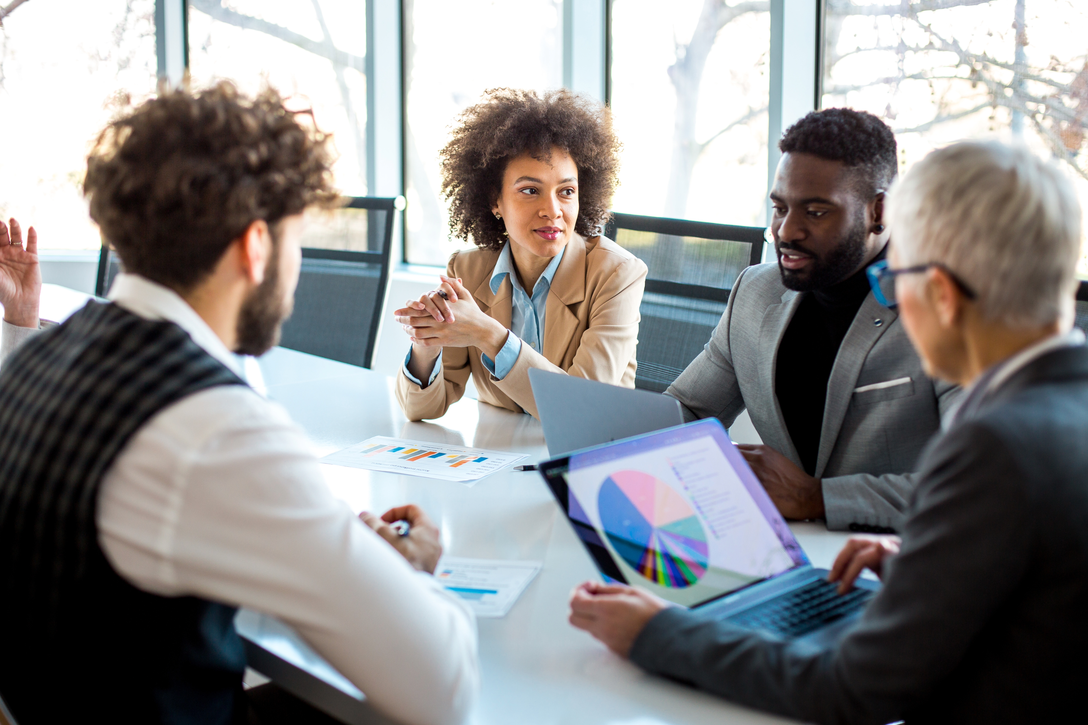 Professionals gathered around a conference table during a strategic hiring discussion